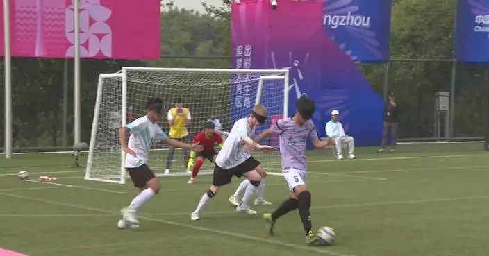 Volunteers help blind footballers at Games for Persons with Disabilities