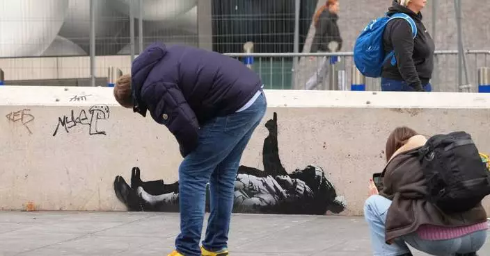 Banksy unveils new art in London following speculation over murals depicting stargazing figures