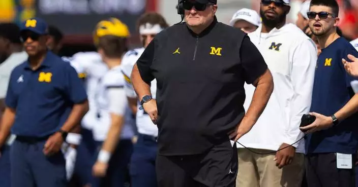 Biff Poggi tells signees and parents Michigan hopes to hire a coach by end of month, AP source says