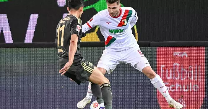 Fan protest against kickoff times interrupts Bundesliga game between Augsburg and Union Berlin