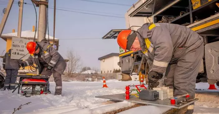 Ukrainians endure freezing temperatures at home as emergency crews rush to restore power