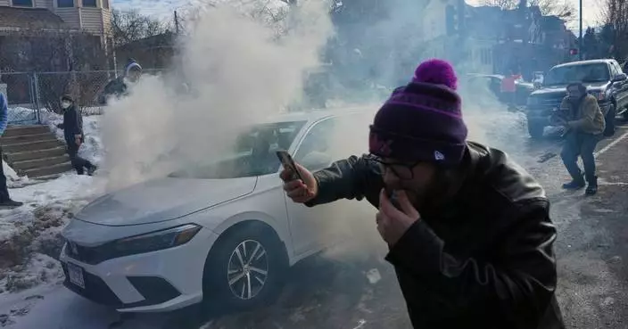 Crowd yells ‘cowards!’ after federal agents crash into a car and fire tear gas in Minneapolis