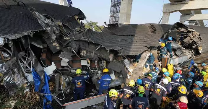 Photos show rescue workers at scene of crane collapse and train derailment in Thailand