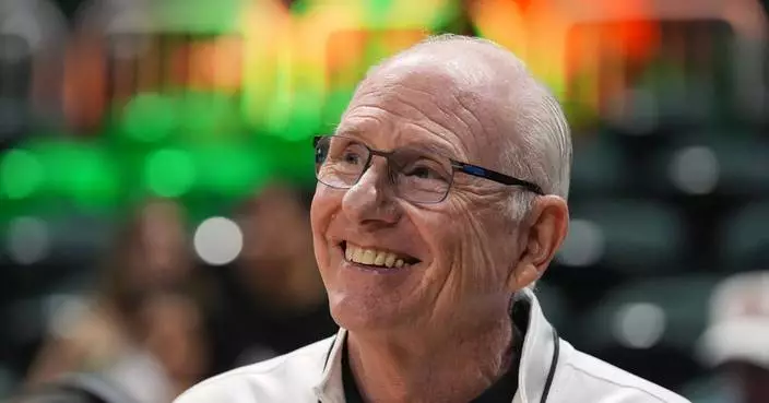 Miami unfurls a banner to honor retired coach Jim Larrañaga, who led the ‘Canes to a Final Four