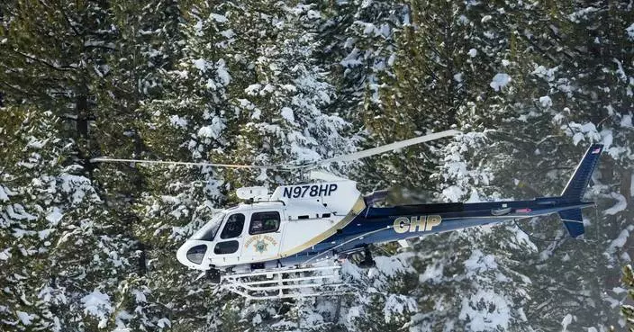 A helicopter heads into California’s Sierra Nevada as crews battle brutal conditions to recover 8