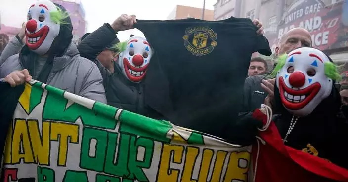 Man United fans wear clown masks in latest protest at club's owners