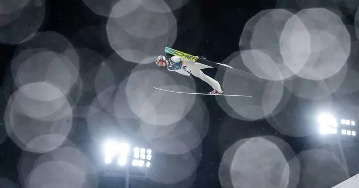 One Extraordinary Photo: Ski jumper glides through rain