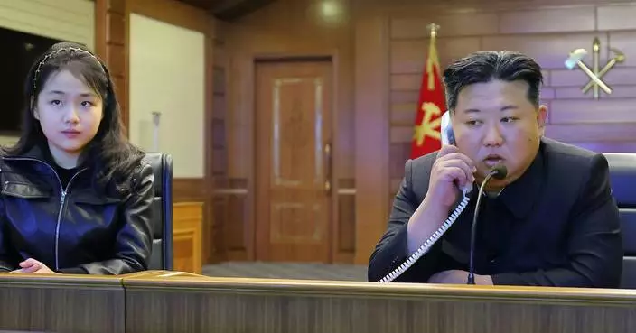 North Korean leader Kim and his daughter try out new pistols at shooting range