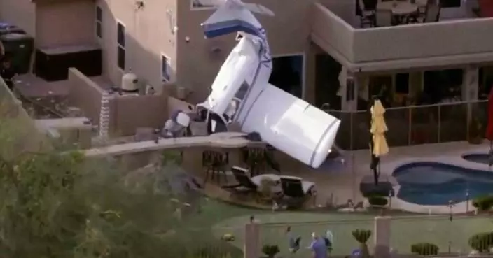 Small plane strikes homes in Phoenix and crashes nose-down next to backyard pool, injuring 3
