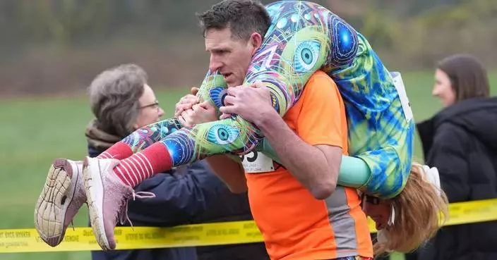 Finnish pair wins a barrel of ale in annual ‘wife-carrying’ contest in England