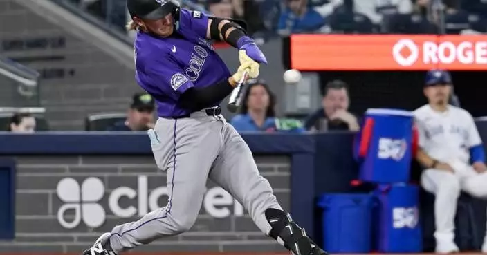 Johnston hits a 2-run homer as the Rockies rout the Blue Jays 14-5 for their 1st win of the season