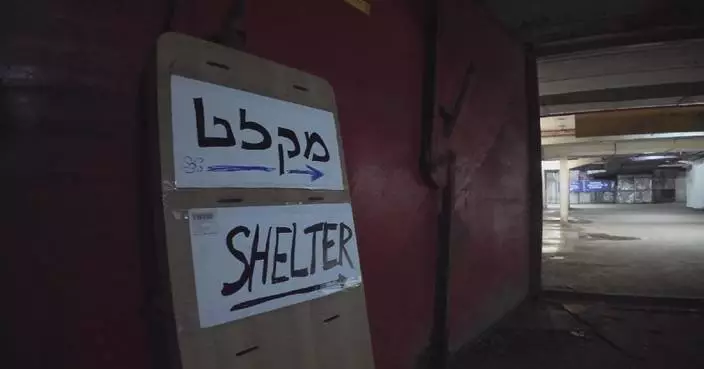 Foreign workers take shelter at underground facility in Tel Aviv as sirens blare