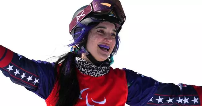 US Paralympian Huckaby brings glitter and a snowboard with photos of her cat named ‘Mouse’