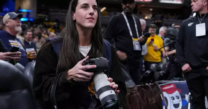 Caitlin Clark works as a photographer for the Indiana Pacers as they host LeBron and the Lakers