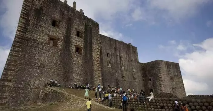 A stampede at a Haitian mountaintop fortress kills at least 25 people and injures dozens