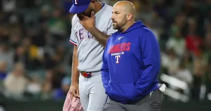 Rangers reliever Luis Curvelo hurt while delivering a wild pitch against the Athletics