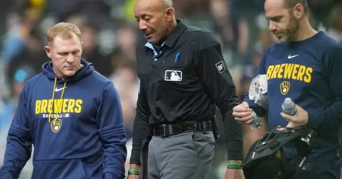 Umpire C.B. Bucknor leaves Rays-Brewers game after foul tip strikes him in his face mask