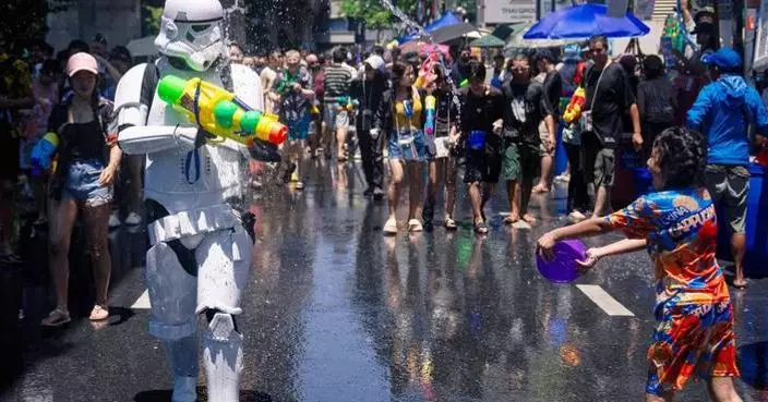 People spray water to celebrate the Thai New Year during the Songkran water festival, in photos