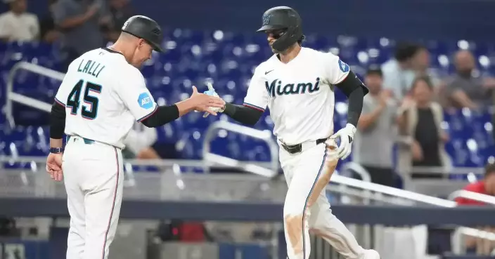 Conine and Norby homer to lead the Marlins to a 7-4 win over the Reds