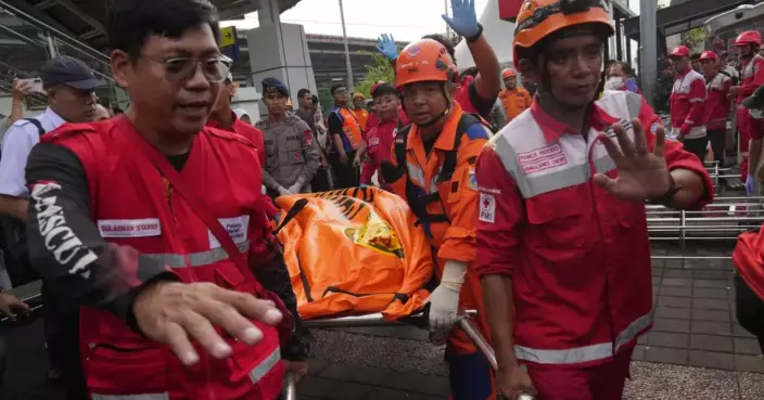 Rescuers recover victims from an Indonesia train crash, in photos