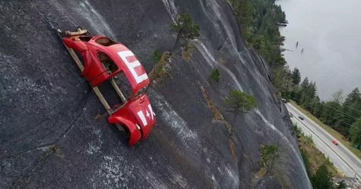 Car shell suspended on rock face above British Columbia highway in apparent prank