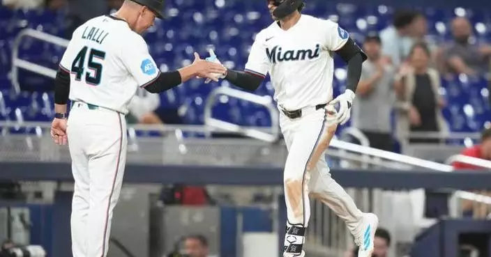 Conine and Norby homer to lead the Marlins to a 7-4 win over the Reds