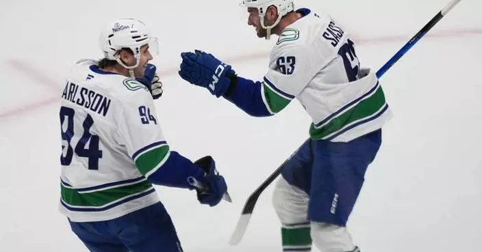 Boeser has hat trick, last-place Canucks overcome blowing 4-goal lead to beat NHL-leading Avs 8-6