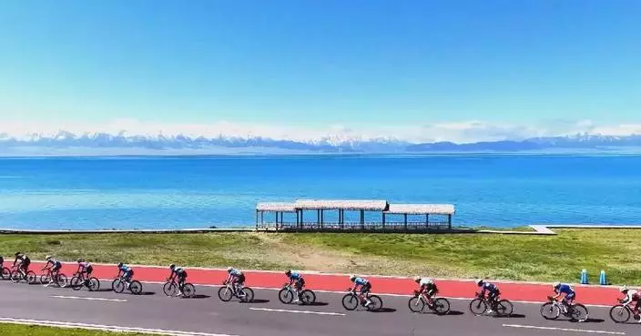 Competitive cyclists steer around stunning scenery of Lake Sayram in Xinjiang