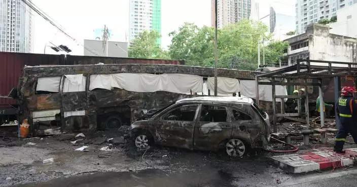 A cargo train hits a public bus at a Bangkok rail crossing, killing at least 8