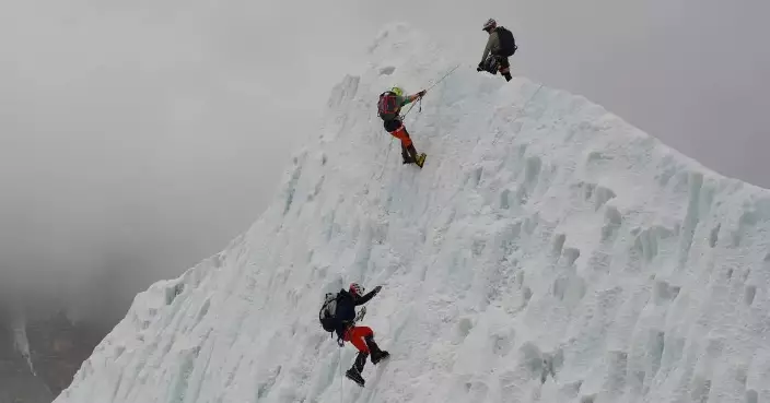 Photos show climbers attempting to scale Mount Everest despite increasing challenges