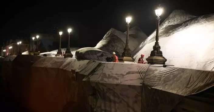 French artist JR begins his giant ‘cave’ art inflation over Paris’ oldest bridge