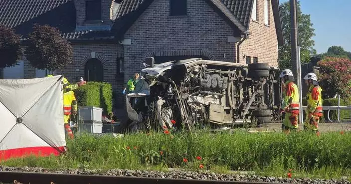 Several hurt in a crash between a train and a minibus, Belgian police say