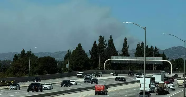 Fast-growing brush fire in Southern California threatens homes