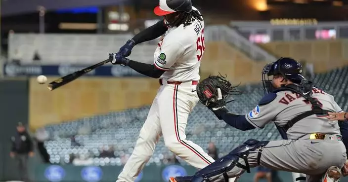 Josh Bell homers twice as Twins beat Astros 6-3 in game delayed nearly 2 hours by rain