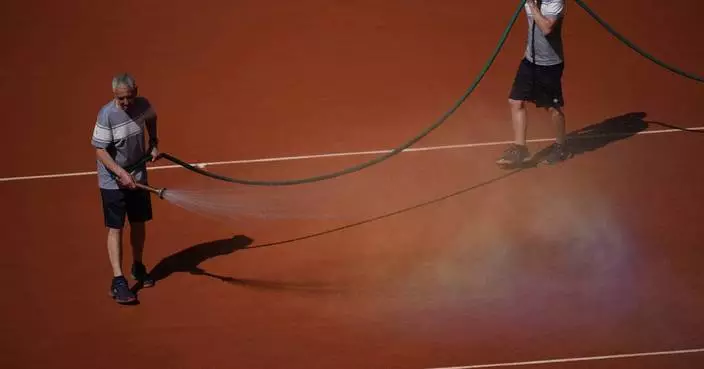 French Open groundskeepers drench the clay courts with water and salt during heat wave