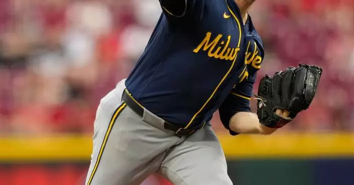Woodruff's stellar return and Ortiz's sacrifice fly in 10th lift Brewers to 2-1 win over Reds