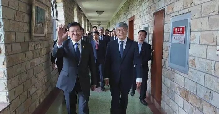 Lao president visits school he attended 26 years ago