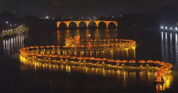 "Golden dragon" of glowing bamboo rafts illuminates Beijing