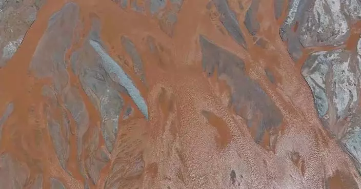 Crimson-colored Xiangride River presents stunning patterns during summer