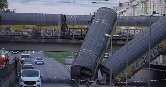 A freight trains' collision in Germany sends 2 wagons plunging off a bridge. One person was killed