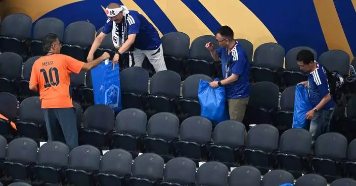 Japan fans use blue bags to uphold a cleansing World Cup tradition after draw