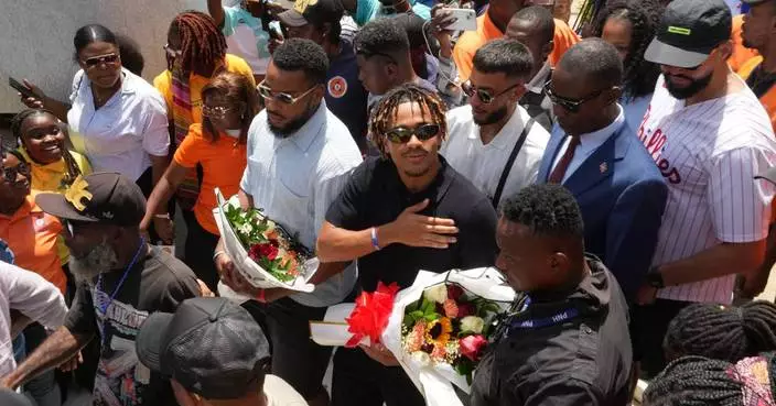 Members of Haiti's national soccer team tour their capital after playing in the World Cup