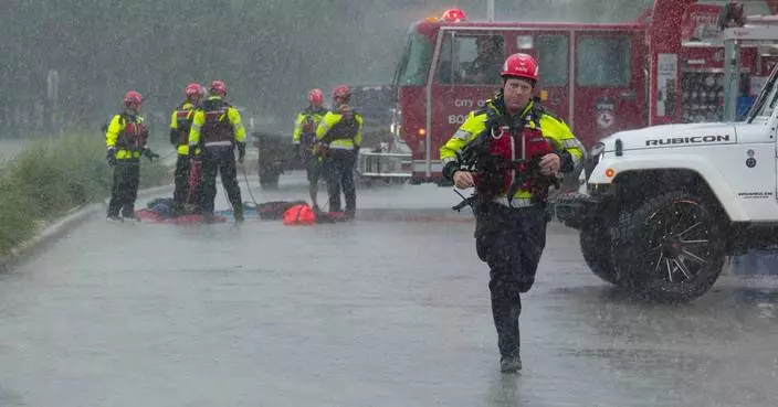 Texas flooding surges from huge rainstorms as rescuers pull people from rising waters