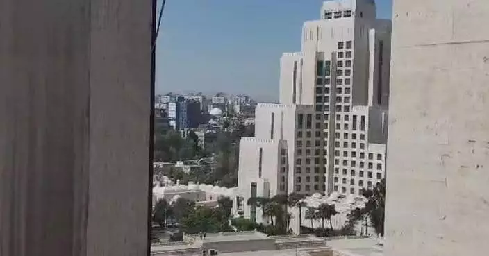 Explosions rock Damascus near hotel where visiting French president stays