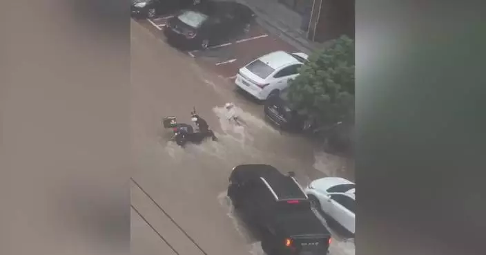 Viral video shows cars preventing delivery driver from being swept away in raging flood