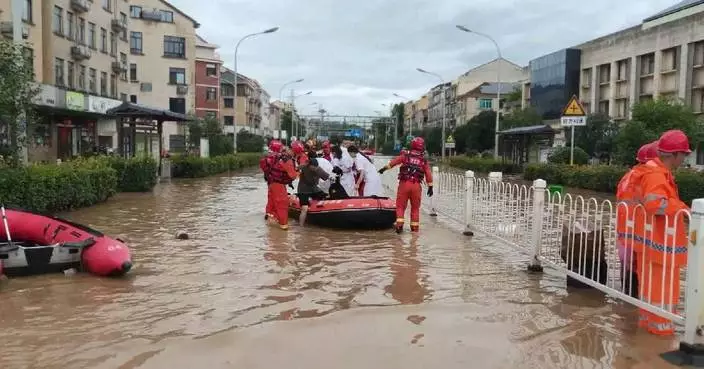 Firefighters evacuate flood-trapped residents in east China as typhoon Bavi brings flooding