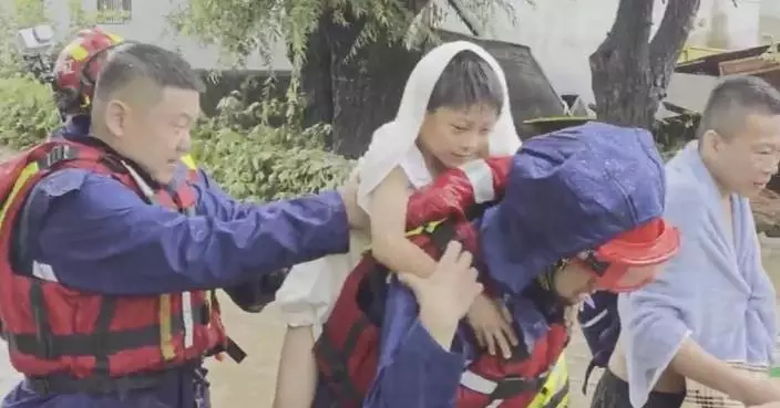 Firefighters rescue people trapped by floodwaters in Liaoning