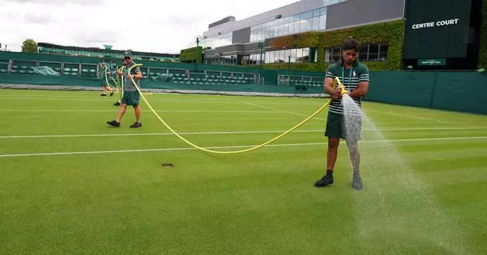 Wimbledon kept its courts lush green as other London lawns browned in record heat