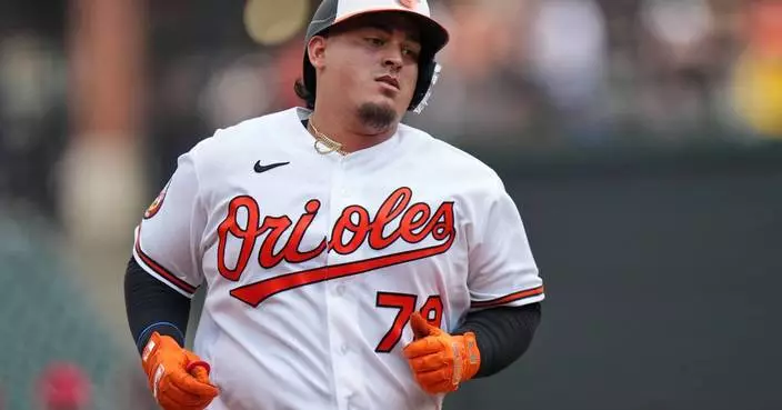 Orioles catcher Yohel Pozo gets hit in hand by Josh Bell's bat, leaves game