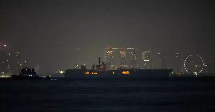 USS Abraham Lincoln sails past Singapore on its way home from Middle East